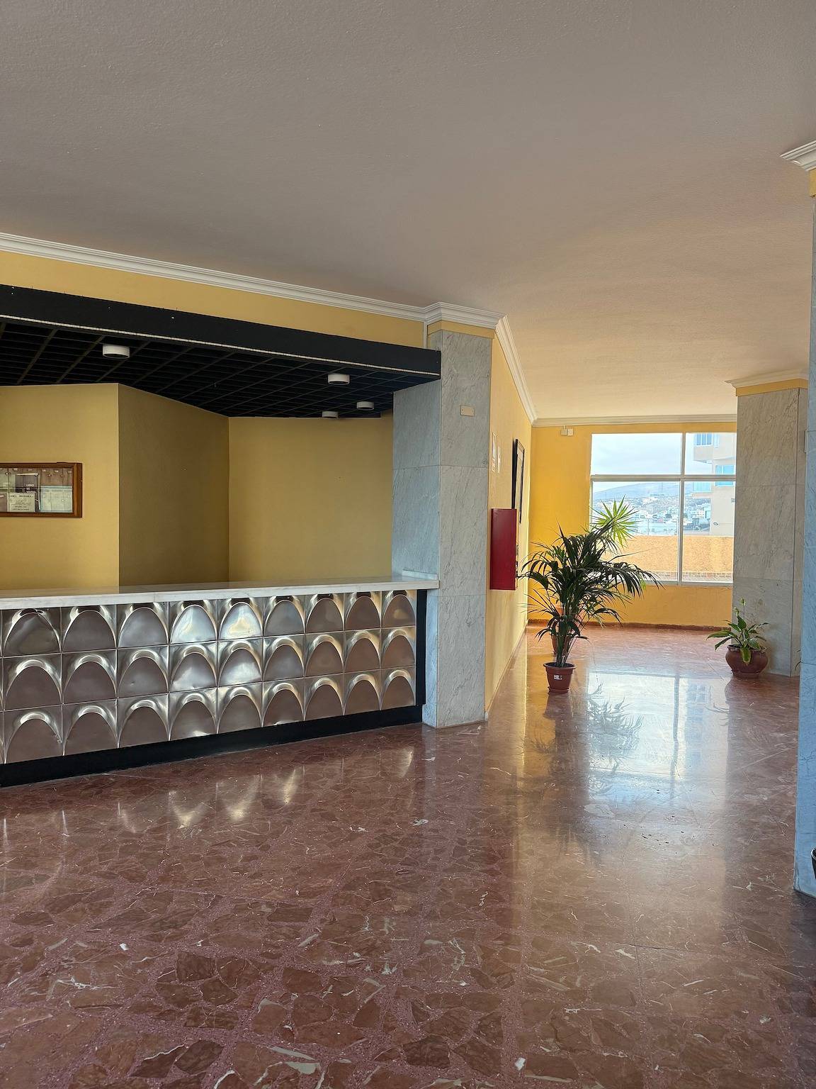 Entrance lobby with a counter and plants